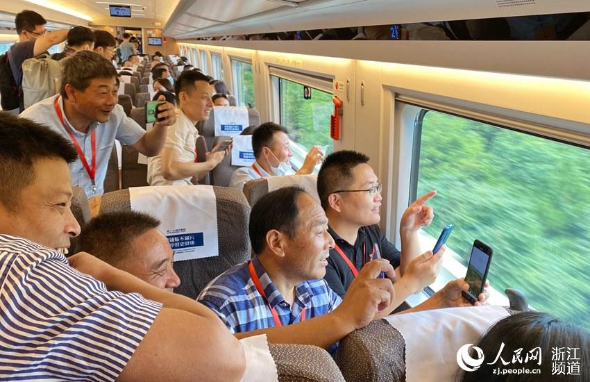 旅客乘坐杭州東至安吉G9398次首發列車，用手機拍攝一路美景。周圍  攝