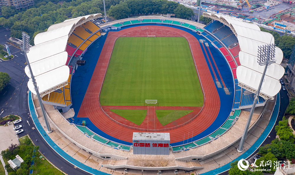 从空中俯瞰浙江省杭州市钱塘江畔的上城区体育中心，鲜艳的红蓝塑胶田径跑道与铺设了大片绿色草皮的足球场相映成景。人民网 章勇涛摄