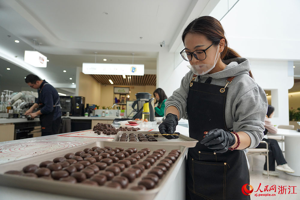 在宁波市镇海区招宝山街道邻里中心，面包师在制作饼干。人民网 章勇涛摄