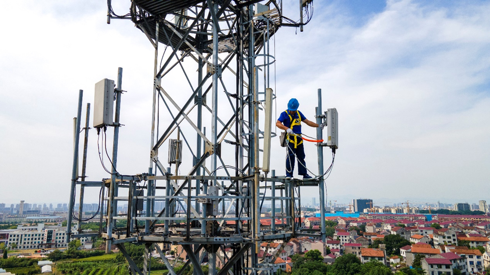 中国电信金华分公司的无线网络工程师冒着高温在通信塔上检修5G设备。中国电信金华分公司供图