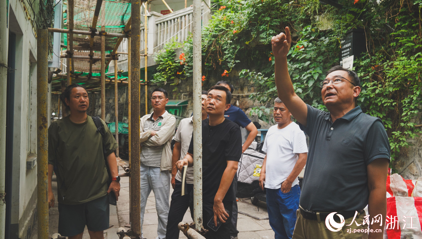 潘守衛（右一）在曉霞弄踩點。人民網記者 郭揚攝