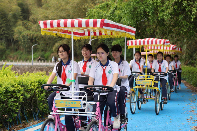 前來研學的學生們在“香溢”綠道上騎行。吳狀攝