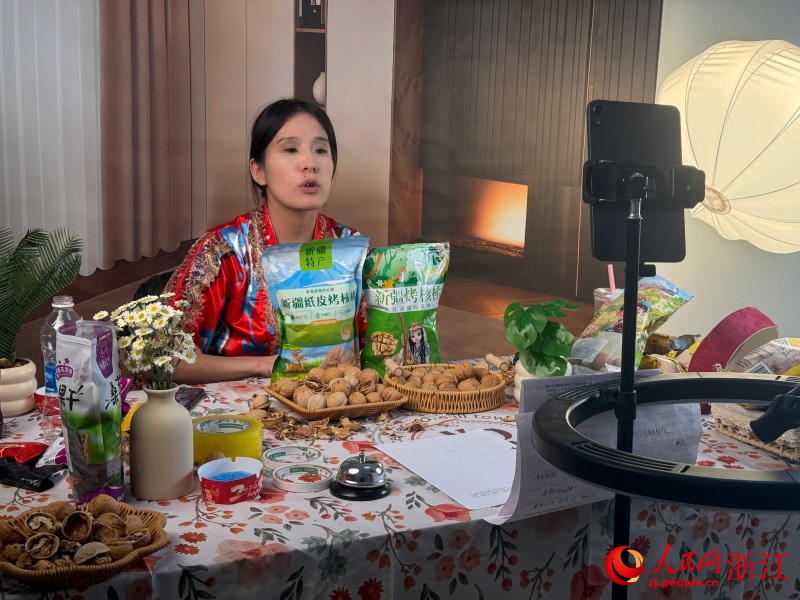 阿克苏市电商创业孵化基地的公用直播间里，创客正在直播。人民网 程欣摄