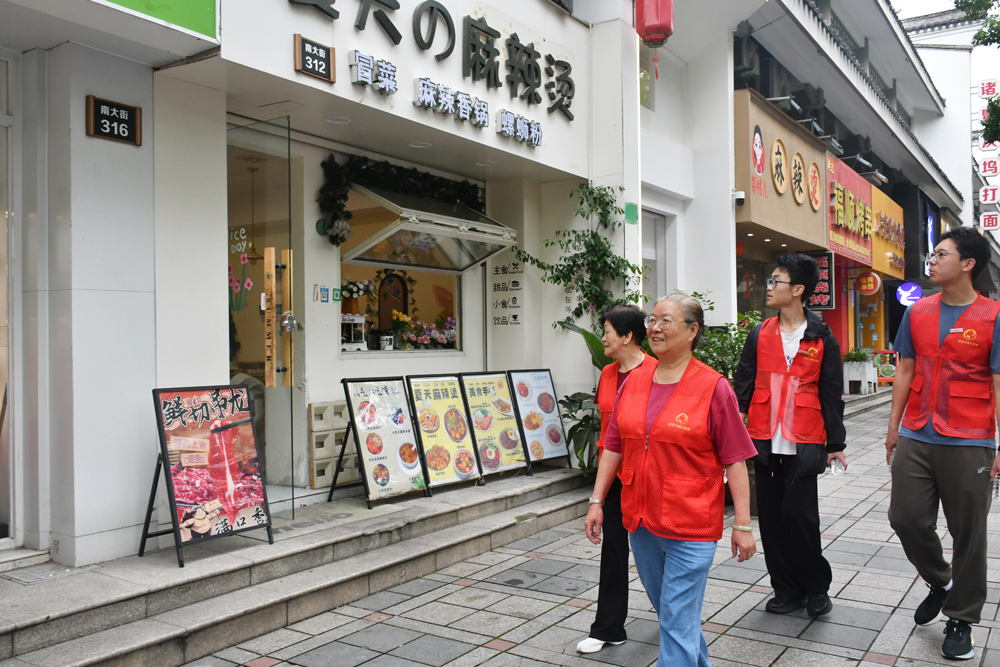 城東社區高考護航志願隊正在走訪考點附近商戶。羅夢圓攝